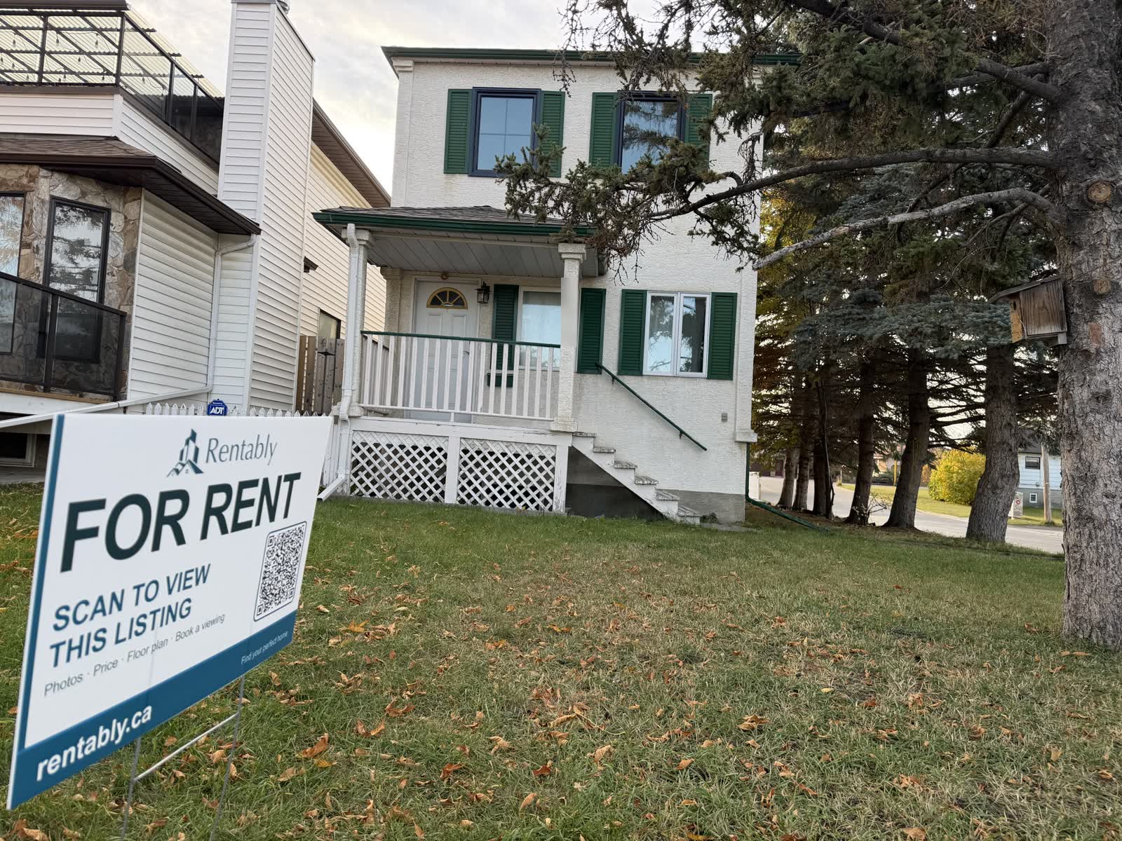 A Rentably For Rent yard sign with a QR code on the front lawn of a Calgary rental home